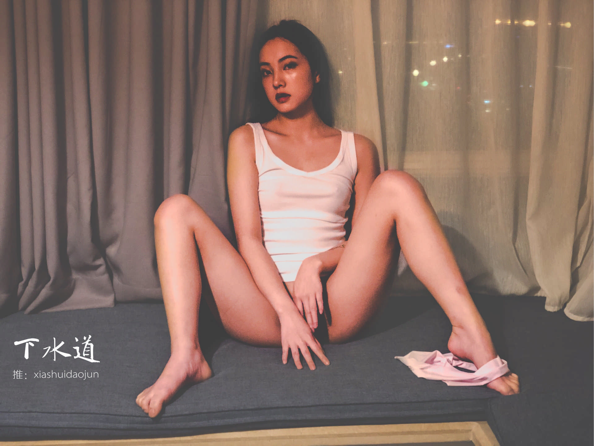 Her skin gleaming under soft light